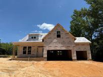Exterior of home in the framing stage, with a two-car garage and covered porch at 235 Atkins Rd, Cameron, NC 28326