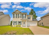 Attractive two-story home with tidy front lawn and an attached one car garage at 31 Boston Hbr, Cameron, NC 28326