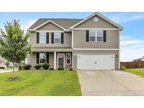 Charming two-story home with gray siding, black shutters, well-maintained lawn, and a two car garage at 641 Avery Pond Dr, Fuquay Varina, NC 27526
