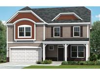 Charming two-story home with a welcoming front porch and a two-car garage, nestled in a landscaped yard at 178 Steeple Ridge, Cameron, NC 28326