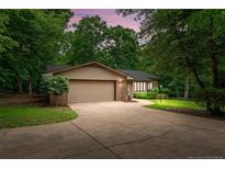 Charming single-story home featuring an attached two-car garage and a well-maintained front yard at 2024 Sandalwood Dr, Sanford, NC 27332