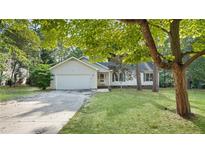 Charming single-story home featuring a well-maintained lawn and an attached two-car garage at 21 Dinghy Dr, Sanford, NC 27332