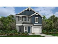 Charming two-story home features a mix of board and batten and clapboard siding, complemented by a manicured front yard at 29 Horse Trot Ln, Sanford, NC 27332
