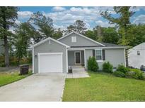 Charming single-story home with attached garage, manicured lawn, and tidy landscaping at 29 York Ct, Spring Lake, NC 28390