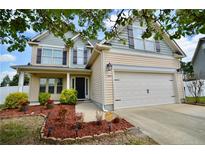 Charming two-story home with a two-car garage and lovely landscaping at 109 Red Coat Dr, Cameron, NC 28326