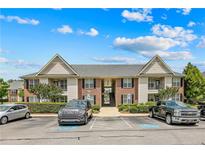 Attractive two-story apartment building featuring brick accents and private balconies, nestled among lush greenery and a parking area at 159 Gallery Dr # 103, Spring Lake, NC 28390