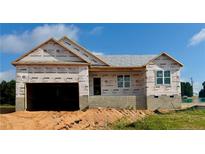 New construction featuring the exterior with garage awaiting its final touches at 211 Uwharrie Way, Sanford, NC 27330