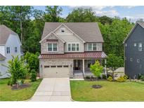 Charming home featuring stone accents, two-car garage and a well-manicured lawn at 405 Gilpin Way, Cary, NC 27519