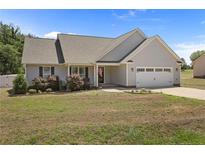 Charming single-story home featuring a two-car garage, well-manicured lawn, and attractive landscaping at 152 Goose Creek Cir, Dunn, NC 28334