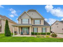 Inviting two-story home with manicured lawn, covered porch, and charming curb appeal at 89 Revolutionary Rd, Cameron, NC 28326