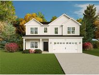 Charming two-story home with a well-manicured lawn, attached two-car garage, and elegant curb appeal at 122 Jones Creek Ln, Lillington, NC 27546