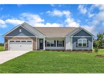 Charming single-story home featuring stone accents, a two-car garage, and a beautifully manicured lawn at 127 Camp Rock Rd, Lillington, NC 27546