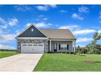 Charming single-Gathering home with a well-manicured lawn and a two-car garage on a sunny day at 155 Camp Rock Rd, Lillington, NC 27546
