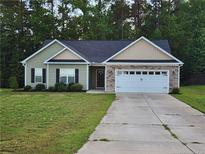 Charming single Gathering home with a well maintained yard and a two car garage at 207 Southwick Ct, Sanford, NC 27332