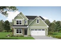 Charming two-story home featuring a black roof, an attached two-car garage and a well-manicured lawn at 339 Hookbill Ln, Lillington, NC 27546
