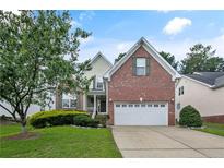 Charming two-story brick home with a well-manicured lawn and an attached two-car garage at 177 Lamplighter Way, Spring Lake, NC 28390