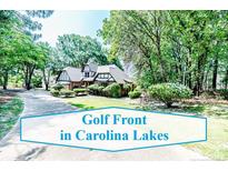 Charming two-story home with brick accents and lush landscaping on a sunny day at 259 Golf Dr, Sanford, NC 27332