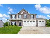 Traditional two-story home with a three-car garage and manicured front lawn at 90 Stock Market Dr, Broadway, NC 27505