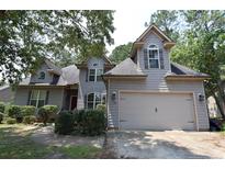 Charming two-story home featuring a well-manicured lawn and a two-car garage at 98 Pineridge Cv, Sanford, NC 27332