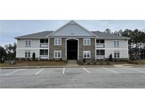Attractive two-story apartment complex with stone accents and ample parking space at 220 Gallery Dr # 201, Spring Lake, NC 28390