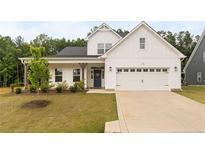 Charming two-story home with white siding, a well-manicured lawn, and a two-car garage at 25 Vast View Way, Youngsville, NC 27596