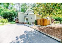 Charming home featuring a two-story facade, complemented by a wooden fence and a lush, landscaped yard at 397 Back Bay, Sanford, NC 27332