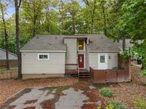 Charming home exterior with a red front door and mature trees providing shade at 968 S Bay Dr, Sanford, NC 27332