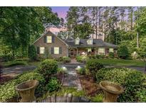 Charming brick home with manicured landscaping and mature trees offering curb appeal at 1409 Brentwood Pl, Sanford, NC 27330