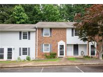 Inviting townhome with brick and vinyl siding, complemented by lush landscaping at 1255 Donaldson Ct, Cary, NC 27511