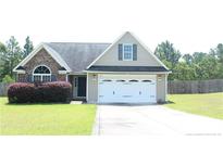 Charming single-Gathering home featuring a two-car garage and manicured lawn at 168 Basket Oak Dr, Bunnlevel, NC 28323