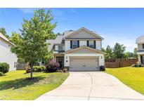 Charming two-story home with a well-manicured lawn and inviting curb appeal in a suburban neighborhood at 18 Hallow Oak St, Spring Lake, NC 28390