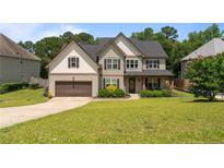 Charming two-story home with a well-manicured lawn, attached garage, and inviting front porch at 364 Heathrow Dr, Spring Lake, NC 28390