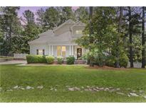 Charming two-story home with a manicured front yard and welcoming porch at 951 Whispering Pines Dr, Spring Lake, NC 28390