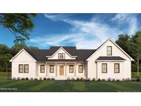 Charming white farmhouse-style home featuring a welcoming front porch and well-manicured lawn at 193 Jim S Rd, Cameron, NC 28326