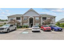 Charming apartment building featuring stone accents, well-manicured landscaping, and convenient parking in front at 291 Gallery Dr # 104, Spring Lake, NC 28390