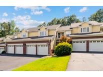 Charming townhome with a brick facade, attached garages and manicured landscaping at 82 Pine Hawk Dr, Spring Lake, NC 28390