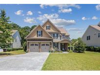 Charming two-story home with a two-car garage and well-manicured front lawn at 50 Turner Mathews Ct, Spring Lake, NC 28390
