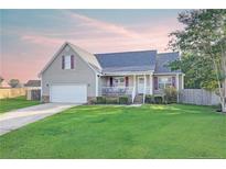 Charming single-Gathering home with well-maintained lawn, attached garage and inviting front porch at 109 Shelby St, Spring Lake, NC 28390