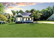 Charming single-story home with a manicured lawn and inviting front porch at 4101 Carson Dr, Sanford, NC 27332