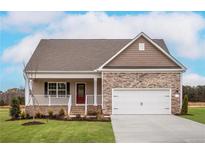 Charming single-Gathering home with a two-car garage and a well-manicured front lawn at 70 Camp Rock Rd, Lillington, NC 27546