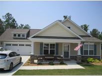 Charming single-story home features a welcoming front porch, attached two-car garage, and manicured lawn at 39 Gold Ct, Broadway, NC 27505