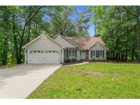 Charming single-story home featuring a manicured lawn and a two-car attached garage at 40 Blue Heron Ct, Sanford, NC 27332