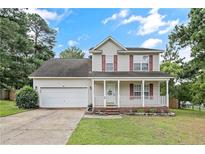 Charming two-story home with a well-maintained front yard and inviting front porch at 69 Ribbon Oak Ct, Sanford, NC 27332