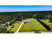 Expansive aerial view of a home and surrounding property with lush greenery at 10110 Nc 27 W Hwy, Lillington, NC 27546