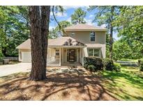 Charming two-story home featuring a covered front porch and attached garage at 1432 Ponderosa Trl, Cameron, NC 28326