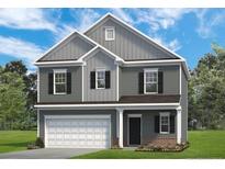 Charming two-story home features a welcoming front porch, attached garage, and classic architectural details at 20 Gray Pine Way, Sanford, NC 27332