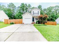 Charming two-story home featuring a garage, front lawn and tasteful landscaping at 3229 Seth Dr, Sanford, NC 27330