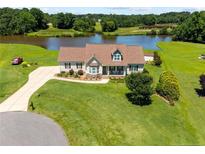 Inviting home with lush lawn and lake view, perfect for outdoor enjoyment at 34 Westchester Ln, Angier, NC 27501