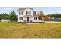 Charming two-story home featuring classic black shutters, dormer windows, and a well-manicured front yard at 38 Beadle Cts, Smithfield, NC 27577