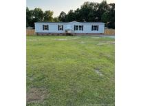 Charming single-story home with a well-maintained lawn and inviting front entrance at 92 Rad St, Lillington, NC 27546